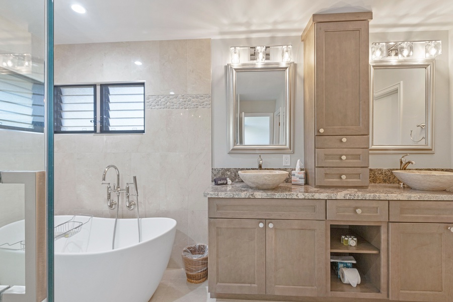 This elegant bathroom offers a luxurious freestanding tub, perfect for a relaxing soak after a long day.