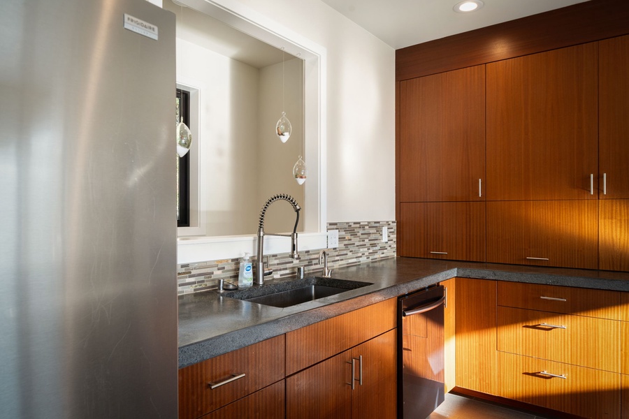 Features warm wood cabinets, granite counters, and a professional-style faucet for effortless meal preparation.