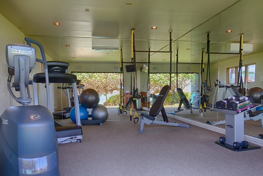 Gym with glass sliding doors and full ocean view