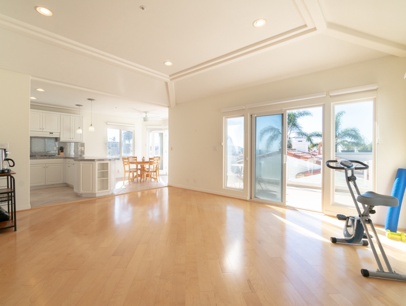 Seamlessly connected to the kitchen, the fitness space beckons with access to the patio