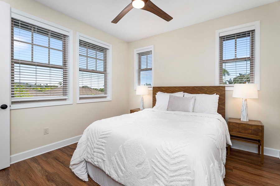 Bright and cozy third guest bedroom with ample natural light and elegant bedding.