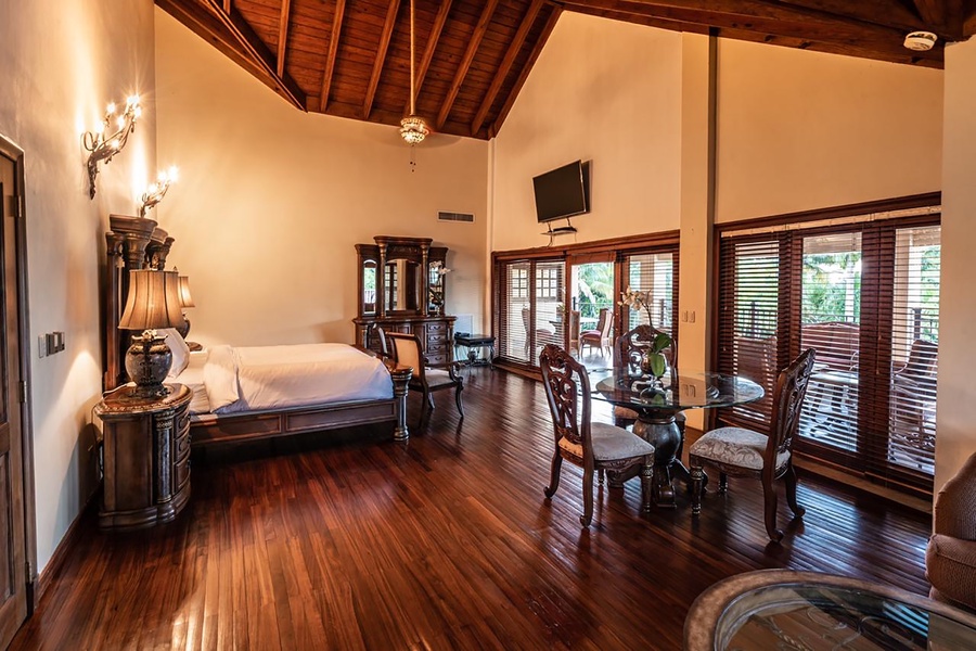 Elegant primary bedroom with a dinette and access to the private patio.
