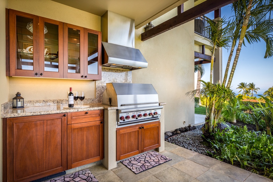 Close up of BBQ grill area showcasing wet bar, prep area, and outdoor mini-fridge.