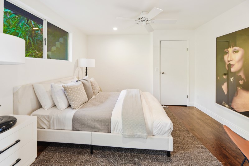 Soft luxe linens ensure a restful slumber amid elegant white surroundings.