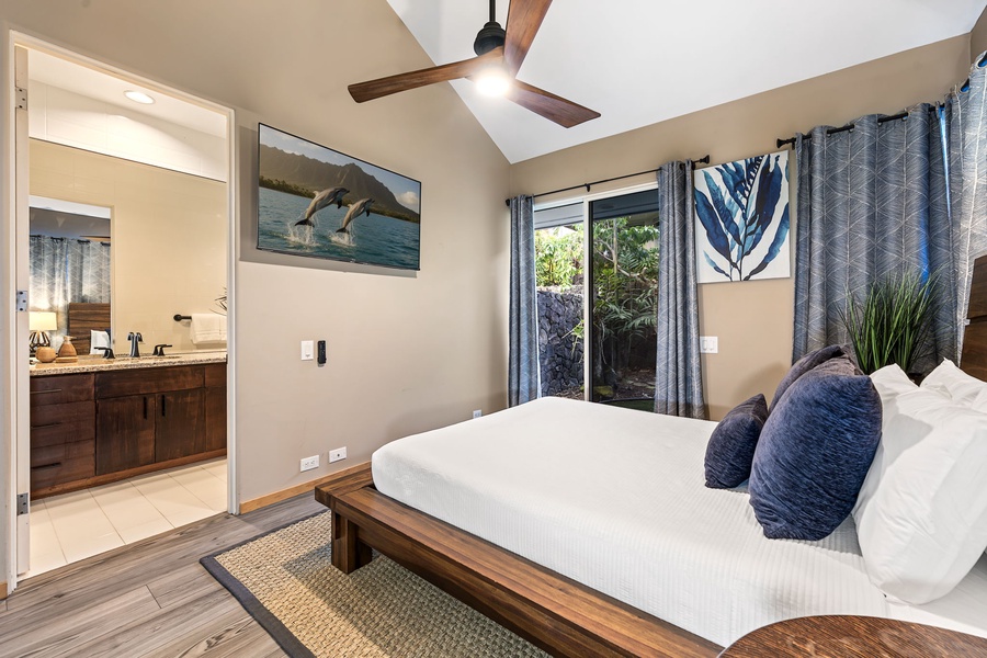 Drift into peaceful sleep in this elegant bedroom featuring crisp white linens and stunning ocean art that captures the island spirit.