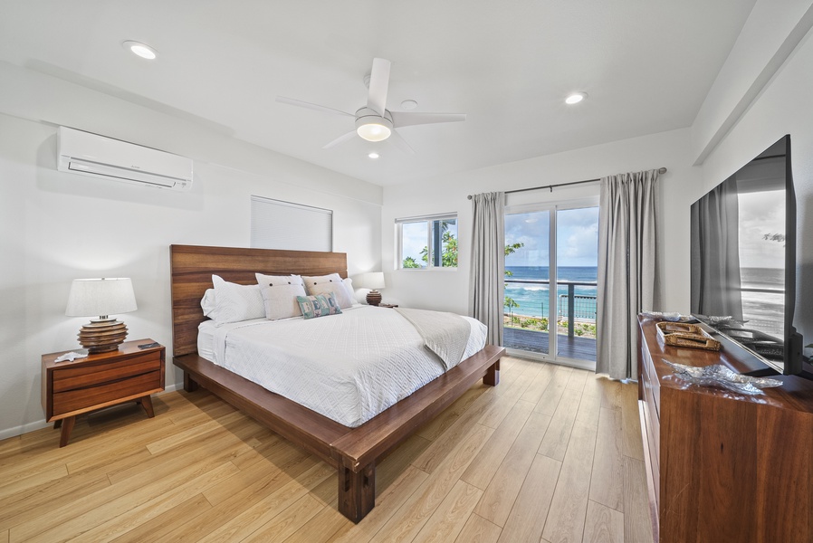 Ocean-view bedroom featuring a cozy California king bed and private access to the balcony—wake up to the soothing sound of waves.