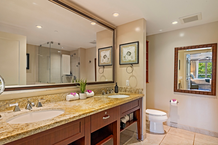 The primary ensuite in Honua Kai Konea 230/232 features dual sinks, plenty of counter space, and a walk-in shower