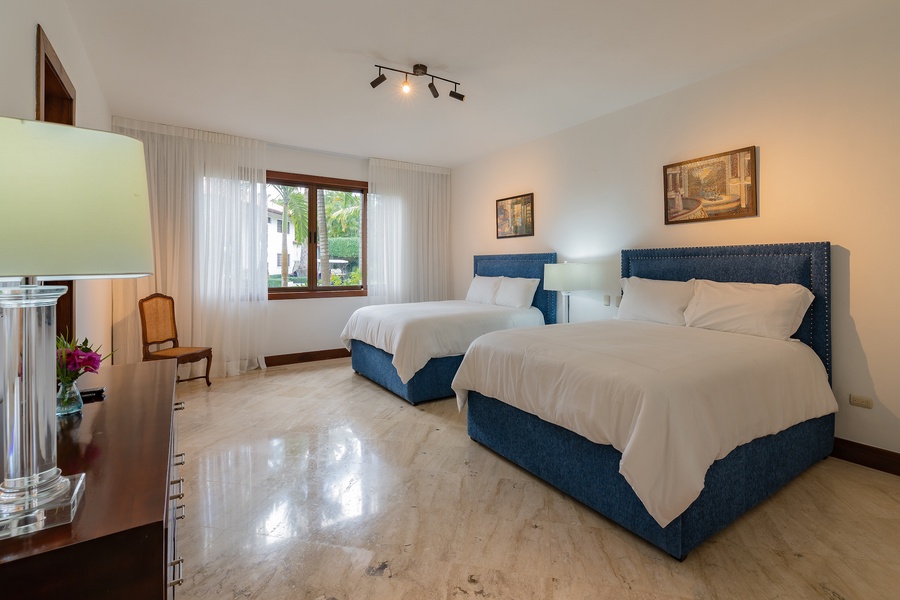 Relax in the spacious bedroom with two beds and large windows.