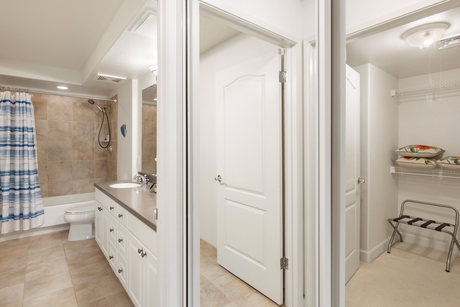 Your spacious bathroom features a relaxing tub-shower combo, generous vanity storage, and thoughtful touches like fresh towels and luggage rack.