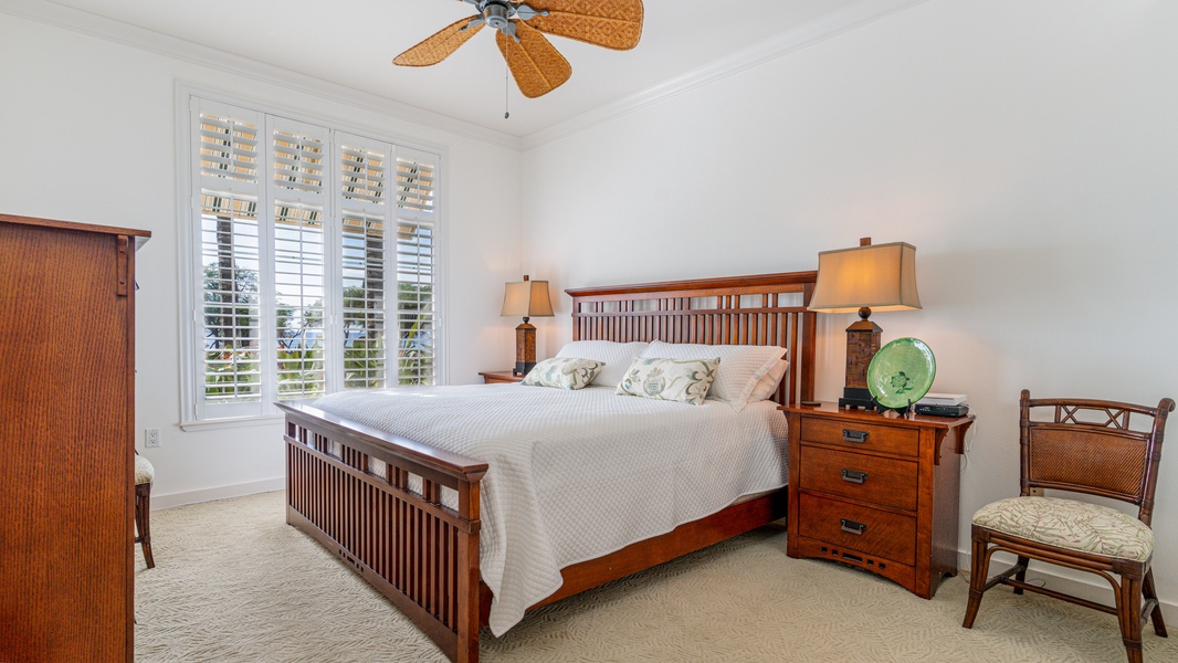 The spacious primary guest bedroom with scenery.