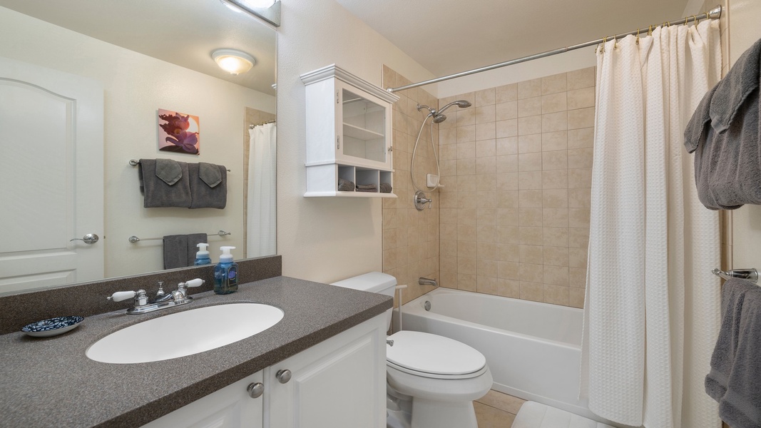 A clean, well-appointed bathroom offering a tub/shower combination and modern finishes for a relaxing end-of-day soak.