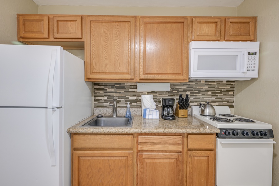 Your kitchen features everything needed for home-cooked meals, with granite counters and warm oak cabinets creating a welcoming cooking space.