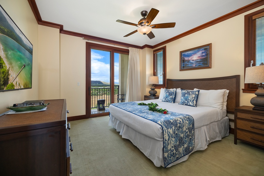 Primary bedroom with TV & private lanai, golf course view, walk-in closet, dual sinks, and a separate tub and shower.