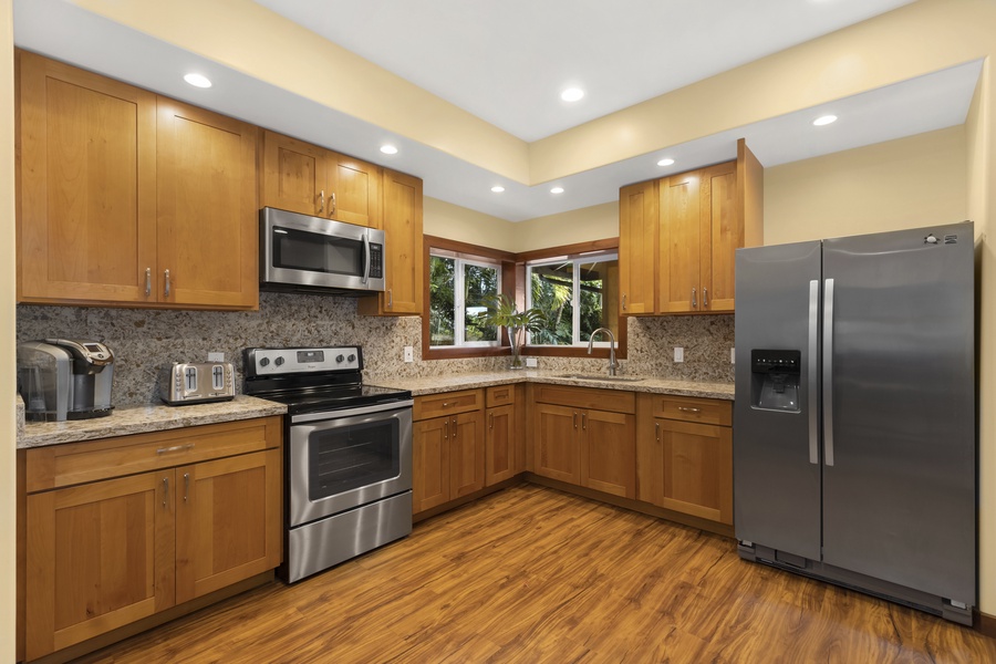 The downstairs full kitchen comes equipped with stainless appliances, a coffee maker, and a toaster.