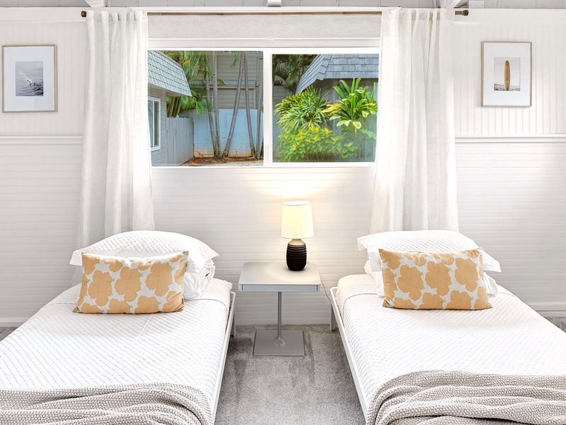 Rest peacefully in your bright twin bedroom with tropical garden views and crisp white linens.