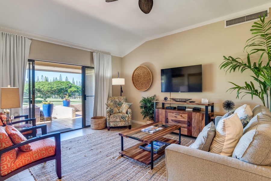 Relax in the inviting living space with a sliding door that opens to the lanai, offering stunning views for an exquisite indoor-outdoor living experience.