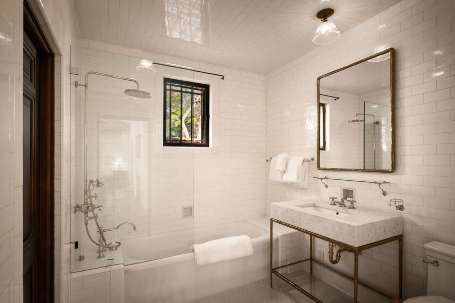 Step into your elegant marble bathroom with brass fixtures, soaking tub, and rainfall shower—pure luxury awaits.