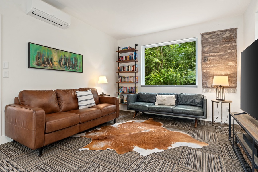The GALBRAITH room doubles as a cozy media lounge with a smart TV and plush leather sofa sleeper.