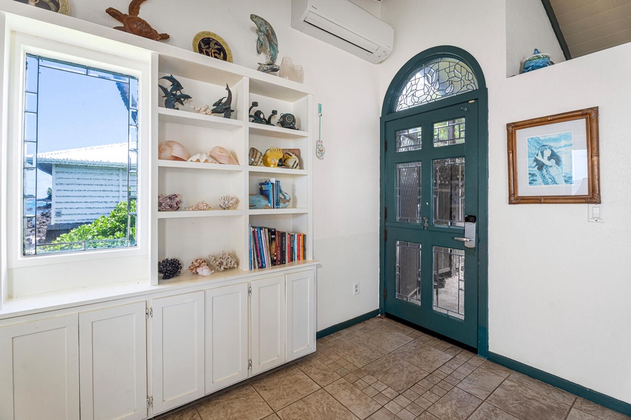 Custom built-in shelving for books and décor, plus direct access to the lanai for oceanfront relaxation.