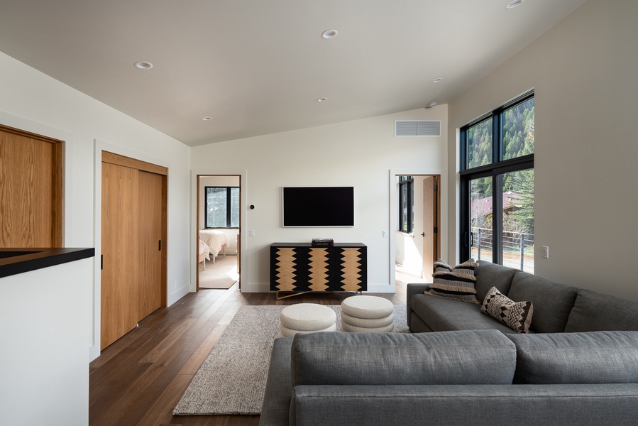 Minimalist upper-level living room with clean lines, natural light, and a cozy layout, offering a peaceful retreat for relaxation and entertainment