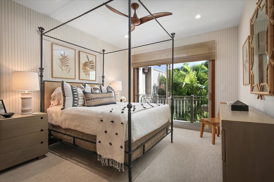 The secondary suite on the upper level boasts a Cal King bed, bathroom, and a private lanai.