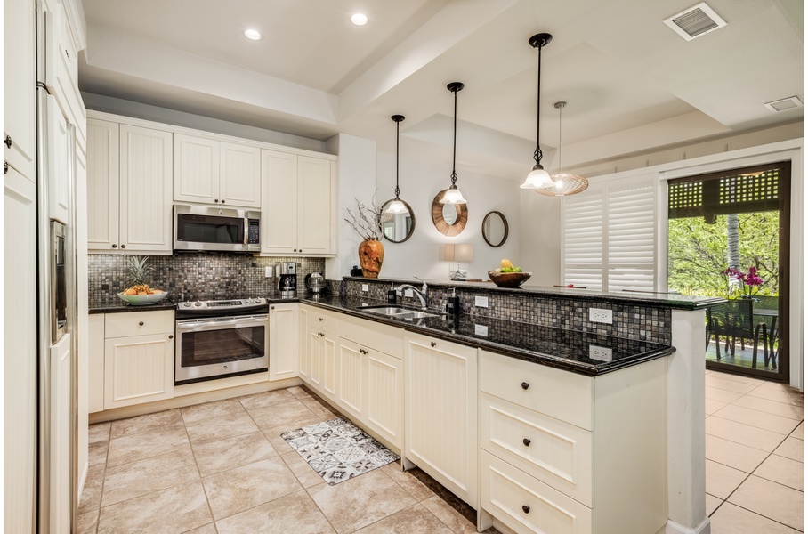 The gourmet kitchen comes with stainless steel appliances to make any chef feel right at home and is detailed with intricate tile work and cabinetry for a stylish atmosphere while preparing meals