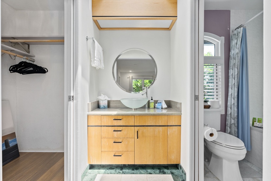 The ensuite bathroom has a single vanity.