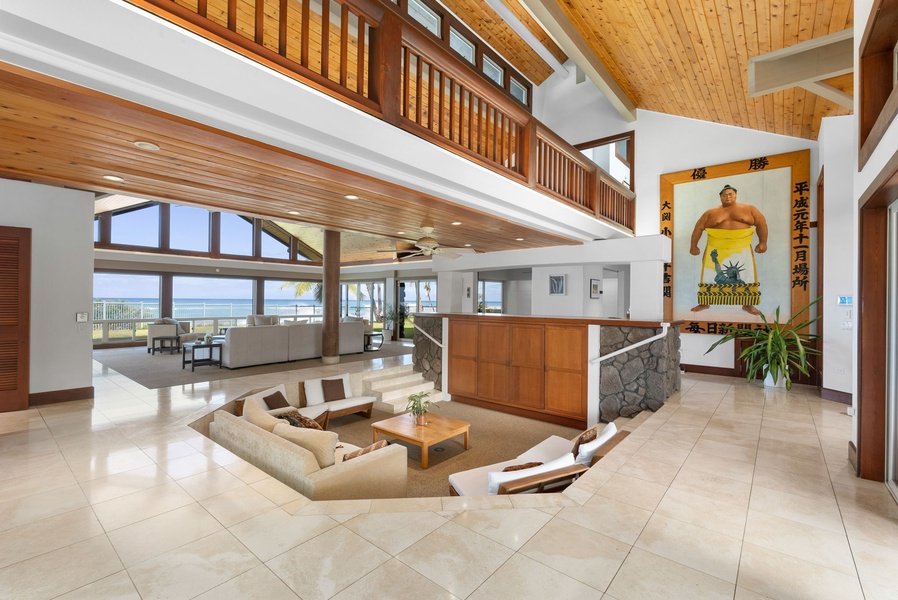 Elegant split-level living area with soaring ceilings and expansive ocean-facing windows.