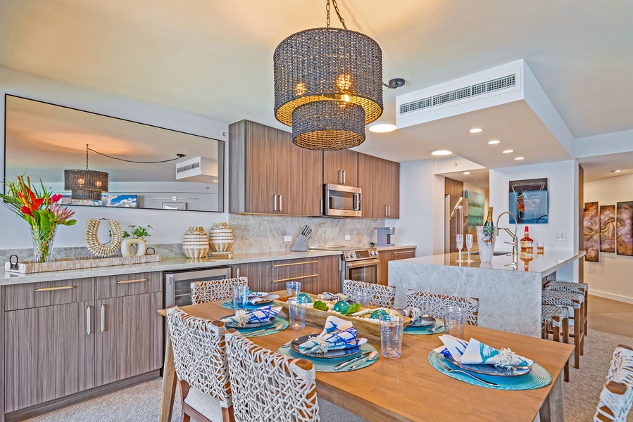 A modern dining space with a view into the fully equipped kitchen, perfect for enjoying meals and conversation.