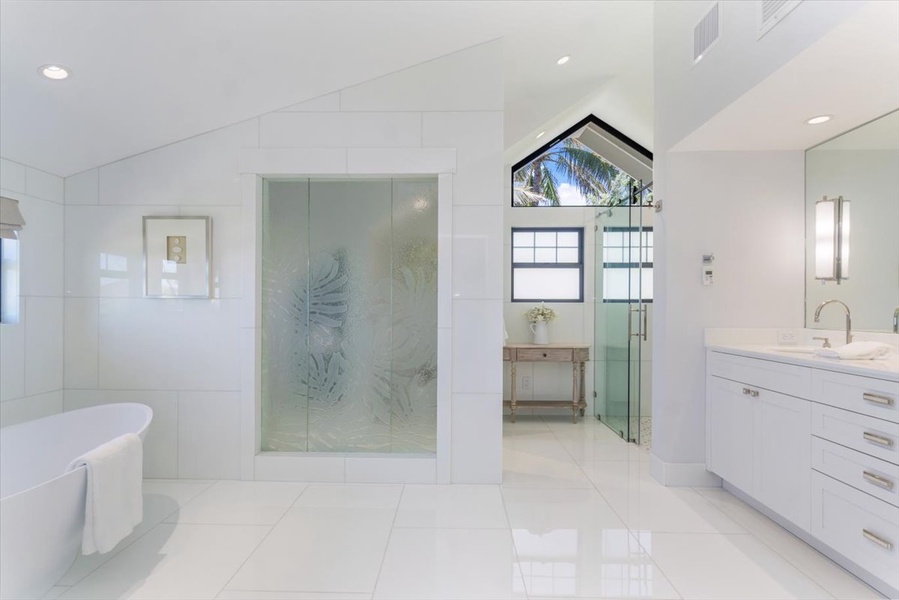 Primary bathroom with freestanding tub, walk-in shower, and dual vanities.