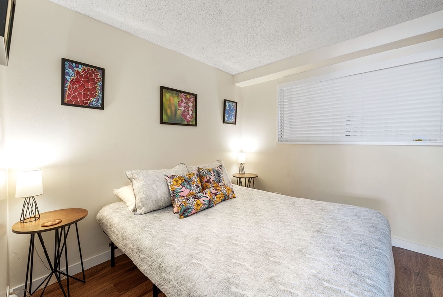 Guest bedroom featuring a queen bed and A/C for added comfort.