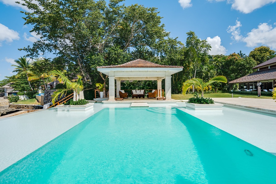 Relax by the pool in the beautiful cabana, perfect for lounging in the shade or enjoying outdoor dining.