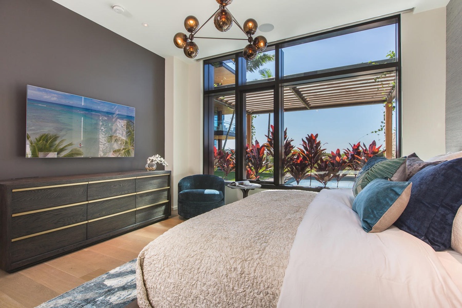 Wake up in your luxurious bedroom with stunning garden views and modern tropical elegance surrounding you.