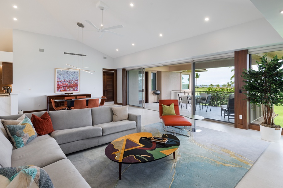 Relax in the stylish living area featuring plush sectional sofas and direct access to the lanai.