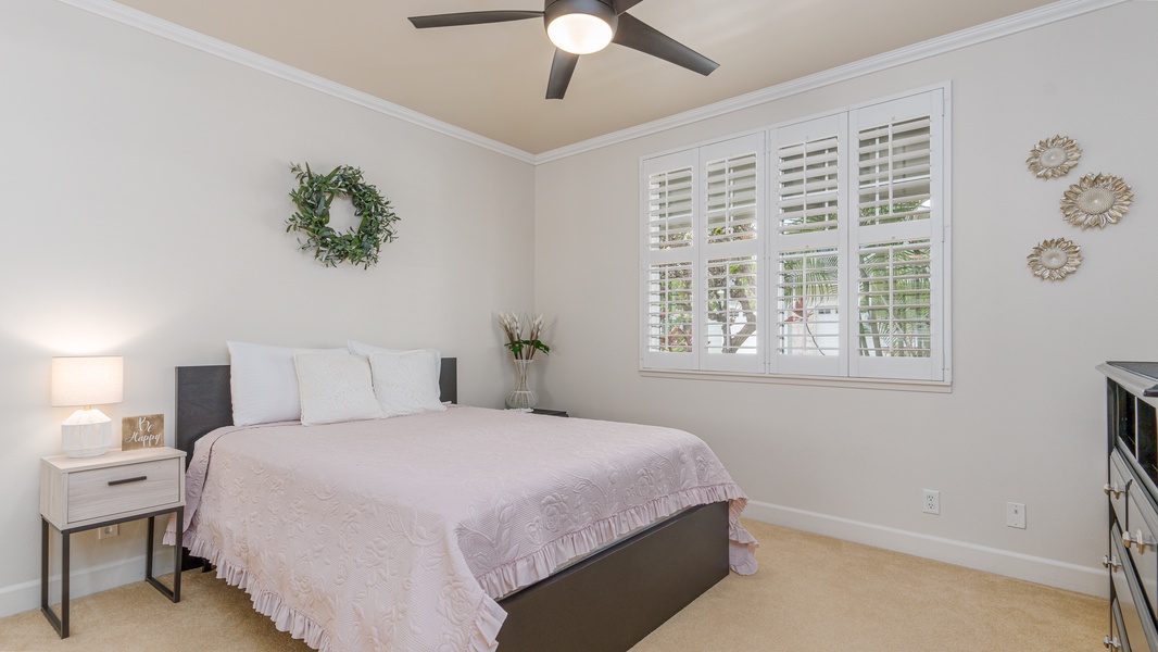 The second guest bedroom featuring views and a ceiling fan.