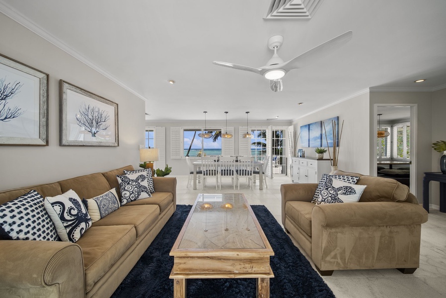 Cozy living area featuring an open floor plan that seamlessly leads to a welcoming dining area and a serene lanai, blending comfort with island luxury.