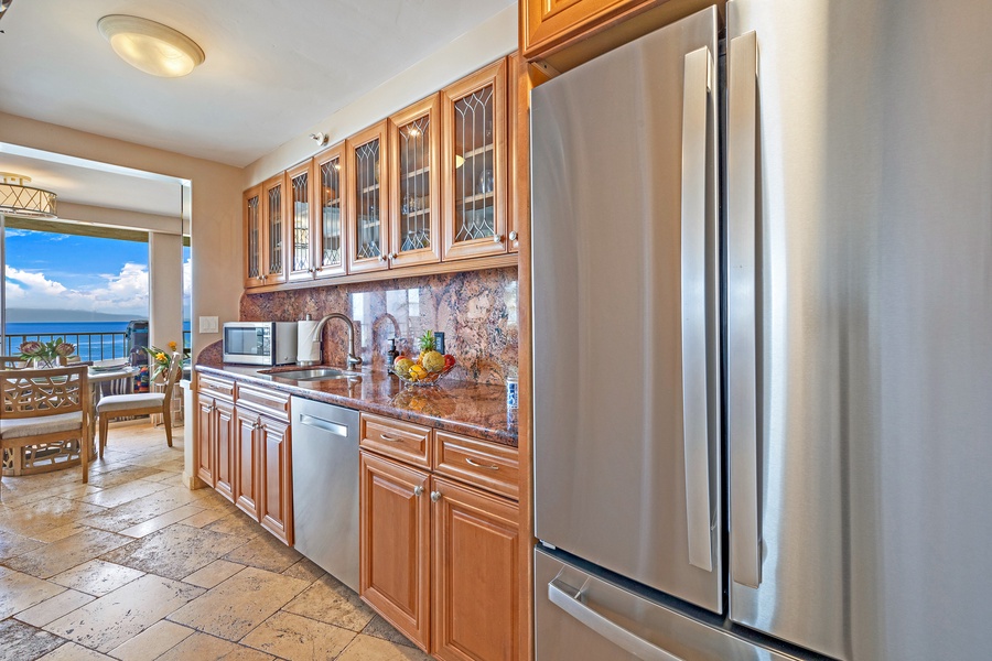 The kitchen includes modern stainless steel appliances and ample cabinet space.