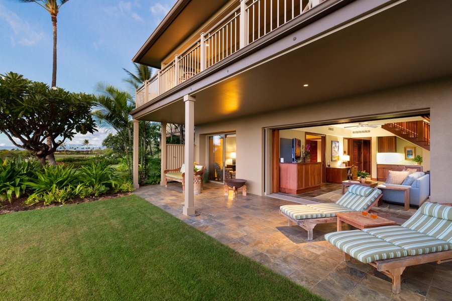 Lower lanai out to a private grassy lawn perfect for watching sunsets and playtime with children.