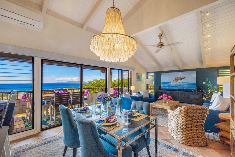 The elegant dining area is perfect for intimate meals, with vibrant blue accents and beautiful views through floor-to-ceiling windows, creating an inviting space to enjoy your surroundings.