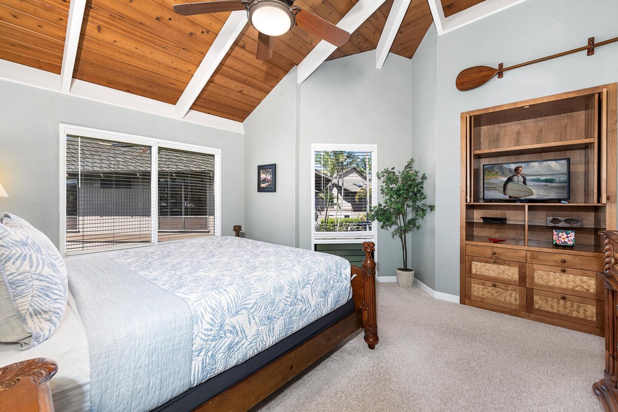 Primary bedroom with vaulted ceilings, ocean views, and king-size comfort.