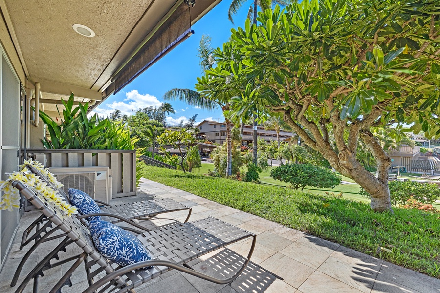Relaxing lanai with lounge chairs & garden views at Kahana Sunset B4B.