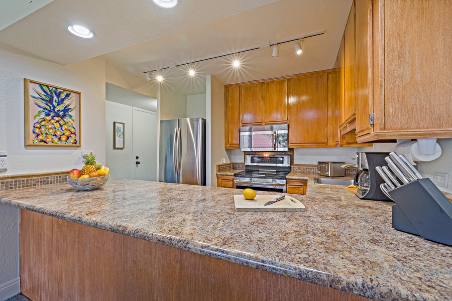 The kitchen offers a sleek design with modern appliances and a large countertop, ideal for preparing meals or enjoying casual snacks during your stay.