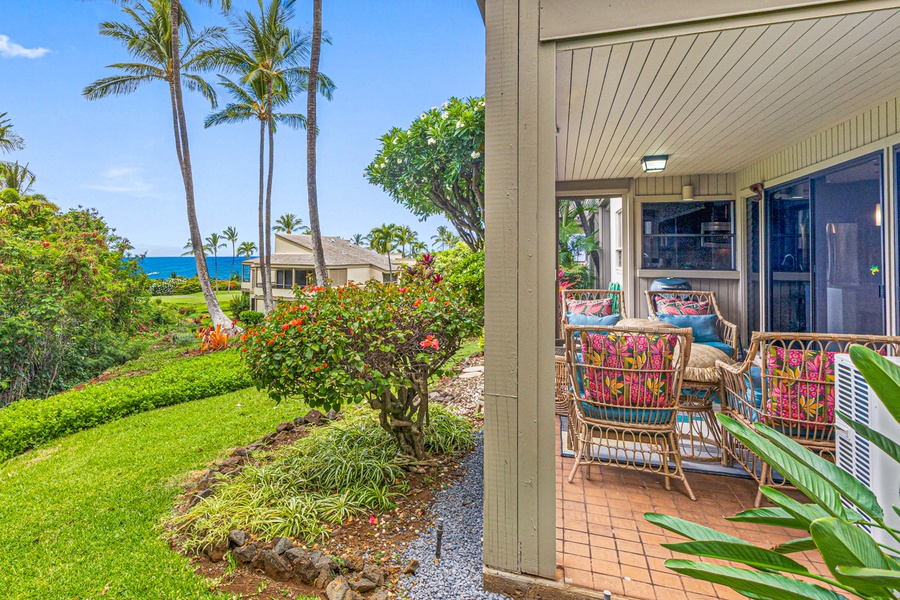 Peaceful lanai views at Wailea Ekolu 1605 with lush greenery and a peek of the ocean.