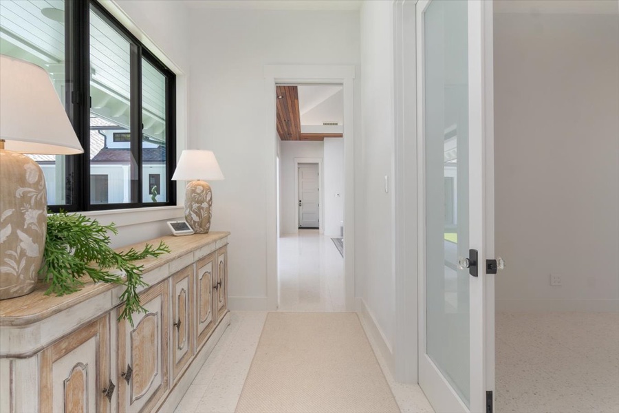 Decorative console hallway connecting main living spaces with bedroom wings.