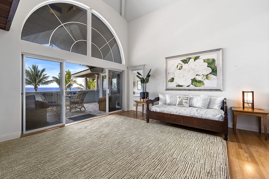 Expansive vaulted ceilings and arched windows fill the primary suite with natural light.