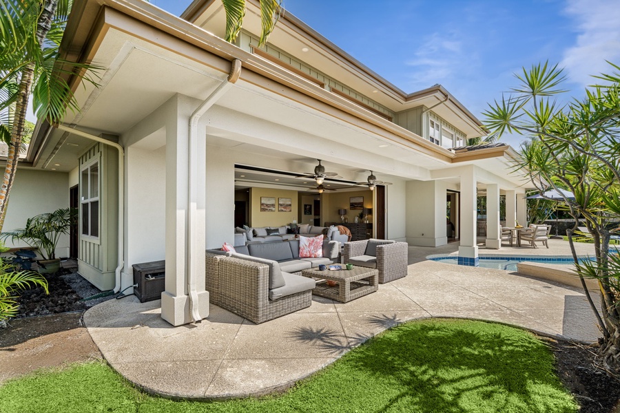 Backyard retreat featuring open seating, dining areas, and tropical greenery.