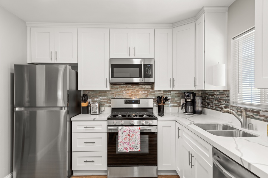 The fully-equipped kitchen with stainless steel appliances makes for easy meal preparation.