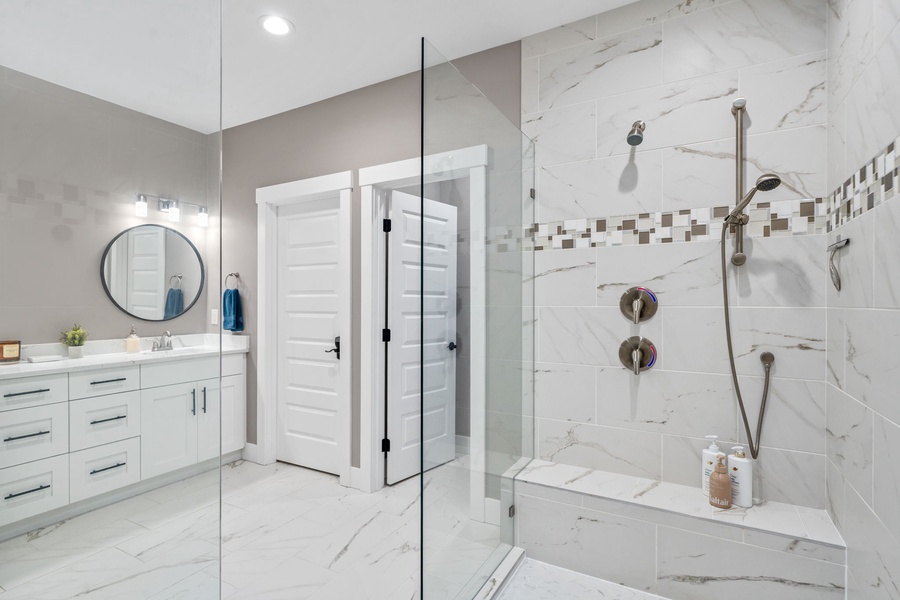 Luxurious marble bathroom with modern fixtures and sleek glass shower for pure relaxation.