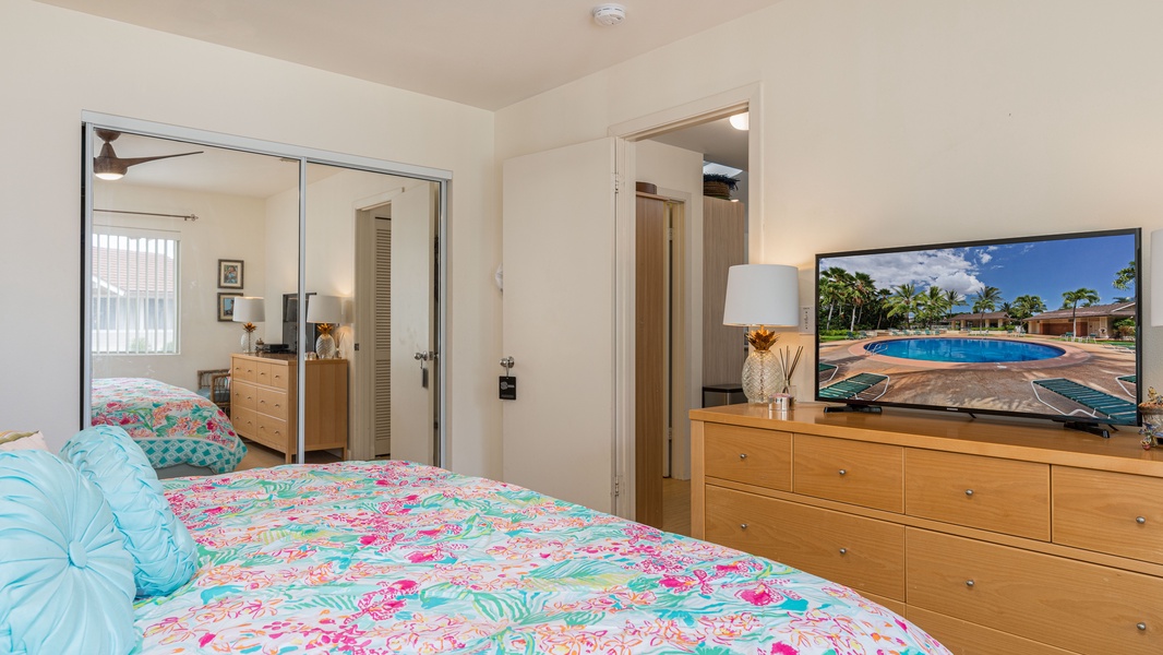 The primary guest bedroom includes a dresser and television.