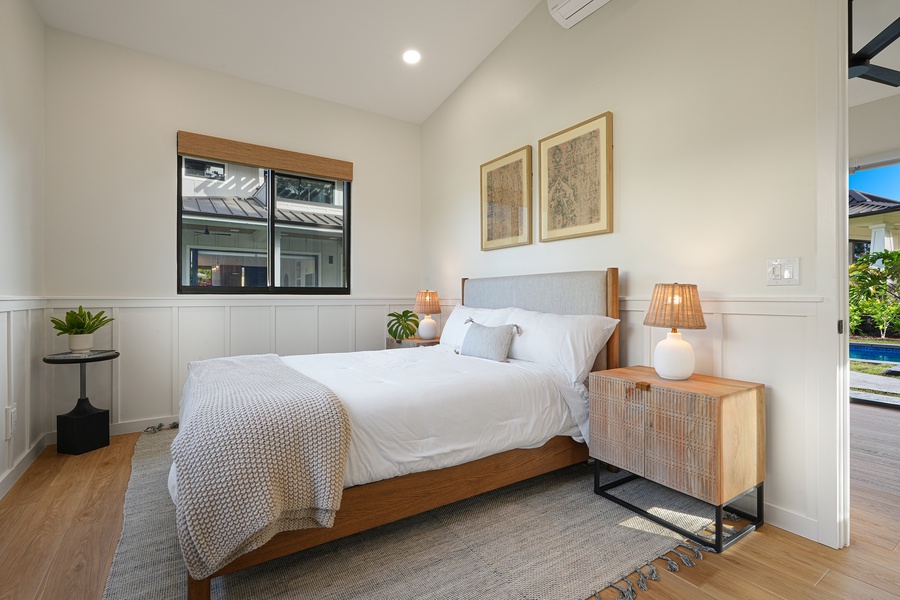 Peaceful fourth guest bedroom retreat with a king and sofa bed, warm accents and soft lighting.